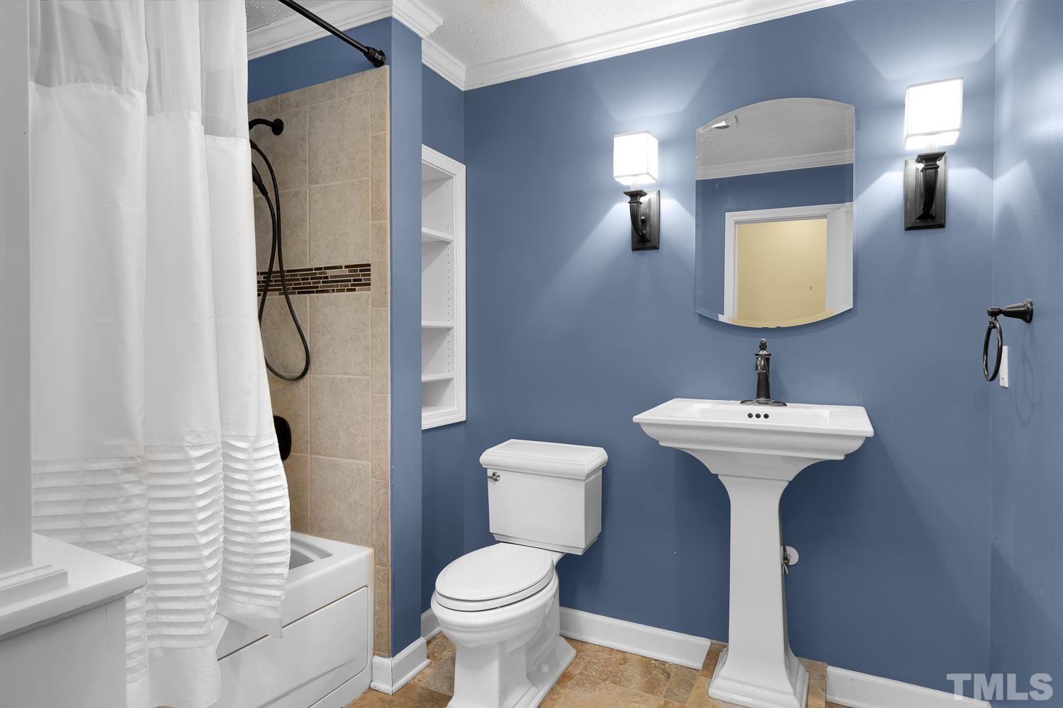 5908 Scalybark Road Durham, NC 27712 - Photo 21 of 30 a bathroom with a sink toilet and shower