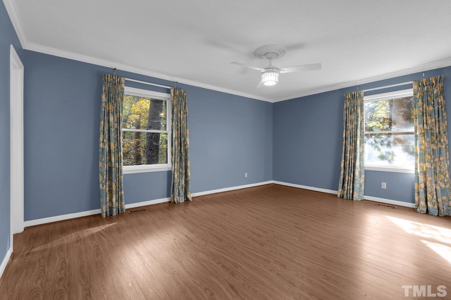 5908 Scalybark Road Durham, NC 27712 - Photo 22 of 30 a view of an empty room with wooden floor and a window