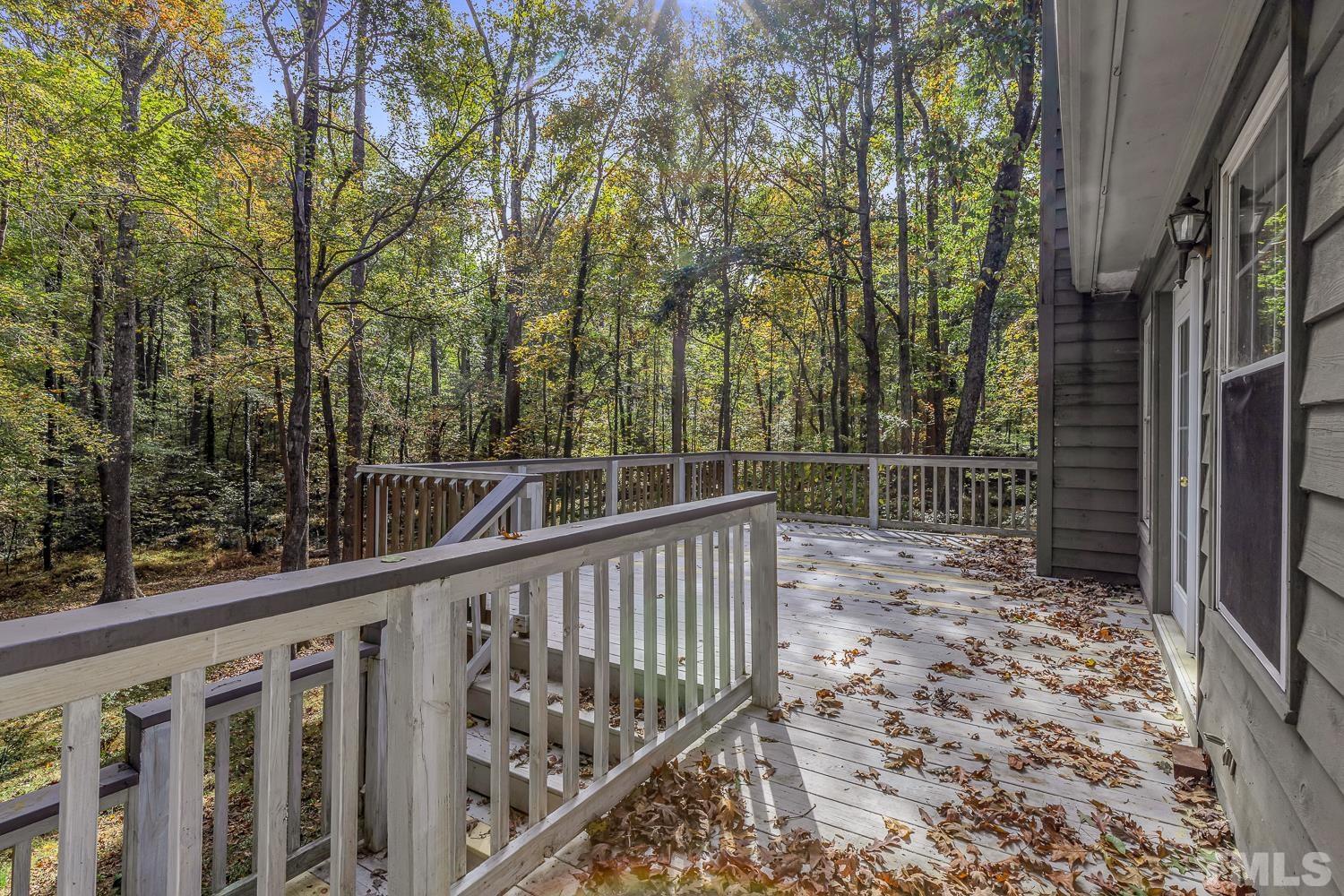 5908 Scalybark Road Durham, NC 27712 - Photo 25 of 30 a view of deck with wooden fence and trees