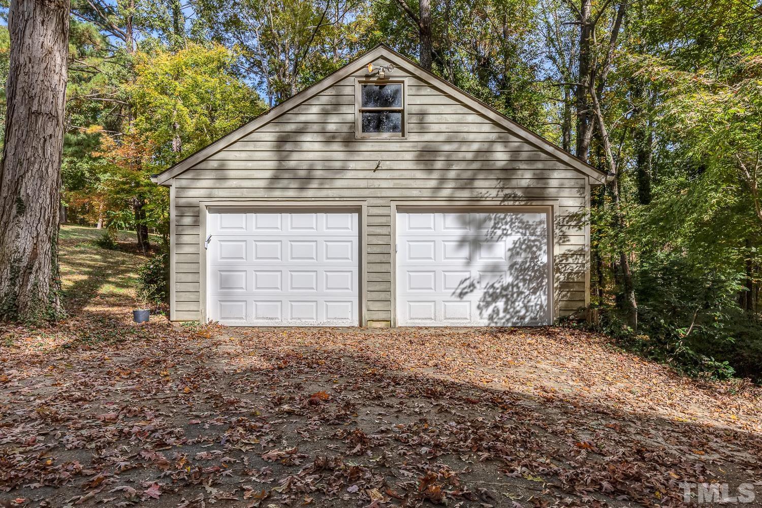 5908 Scalybark Road Durham, NC 27712 - Photo 29 of 30 a view of a house with a yard and garage