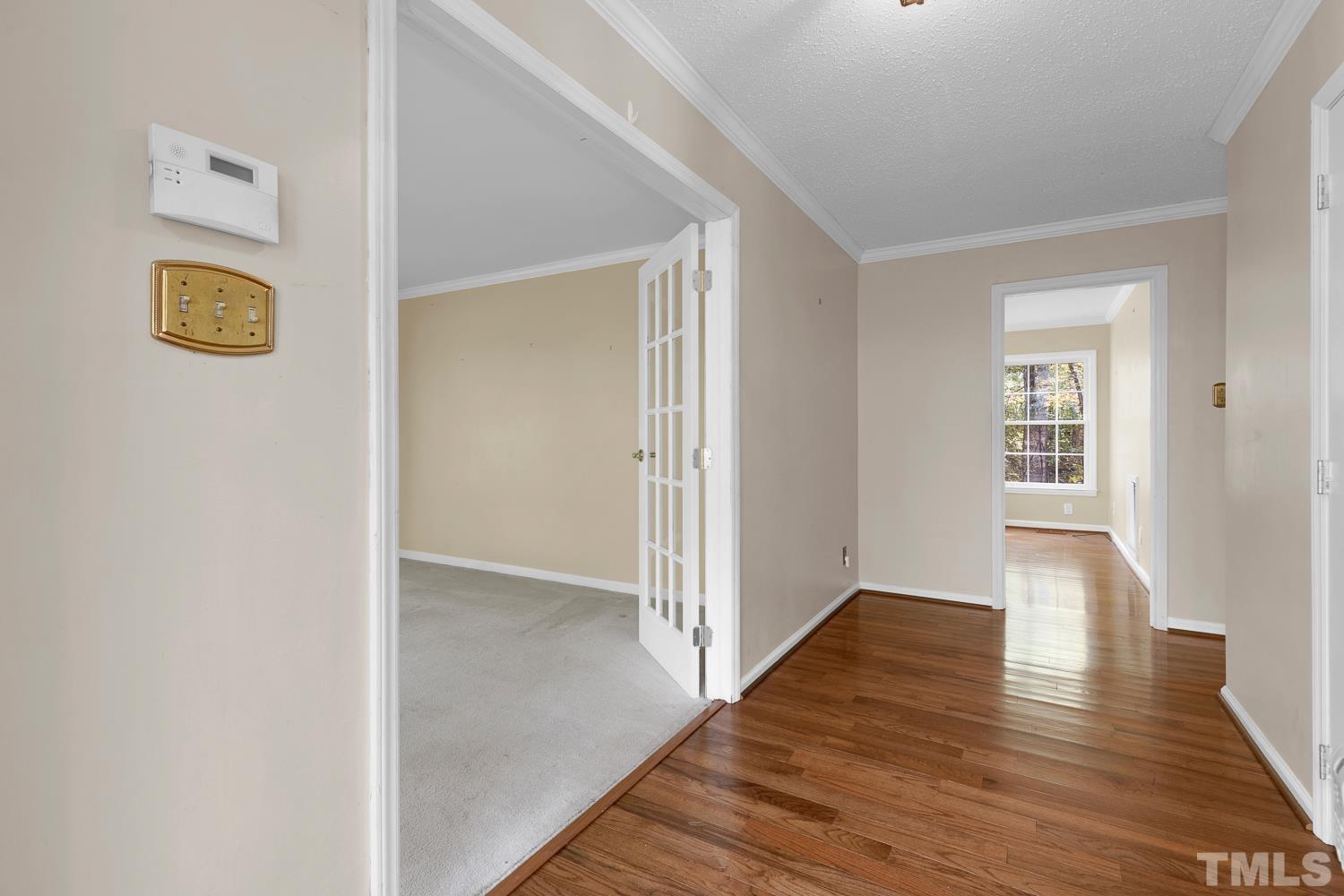 5908 Scalybark Road Durham, NC 27712 - Photo 4 of 30 an empty room with wooden floor and windows