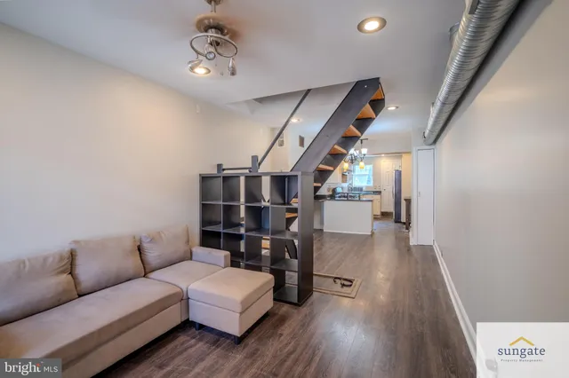 a living room with furniture and wooden floor