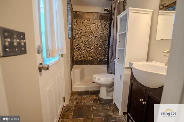a bathroom with a toilet and a shower