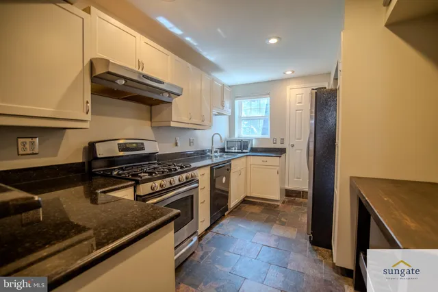 a kitchen with a stove and a refrigerator