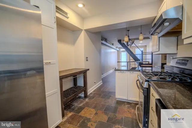 a kitchen with wooden cabinets and a stove top oven