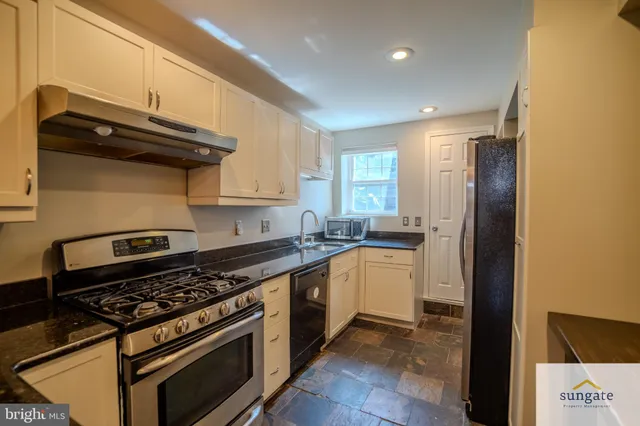 a kitchen with stainless steel appliances granite countertop a stove and a refrigerator