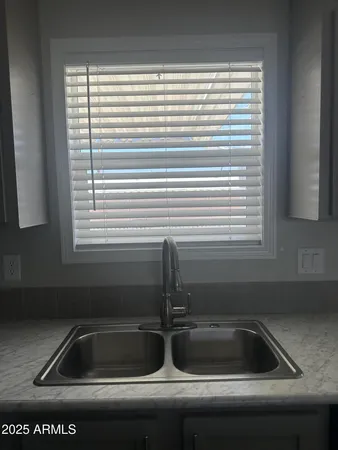 a kitchen with a sink cabinets and a window