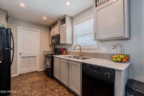 a kitchen with cabinets and stainless steel appliances