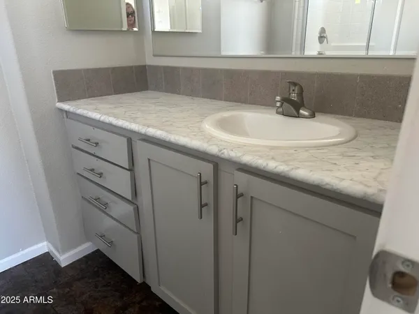 a bathroom with a toilet sink and a mirror