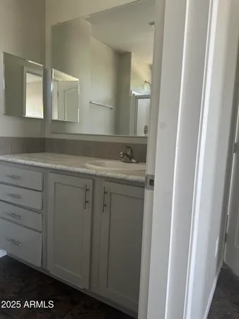 a bathroom with a sink a toilet and mirror