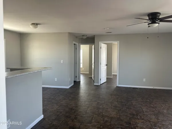 a view of empty room with wooden floor and window