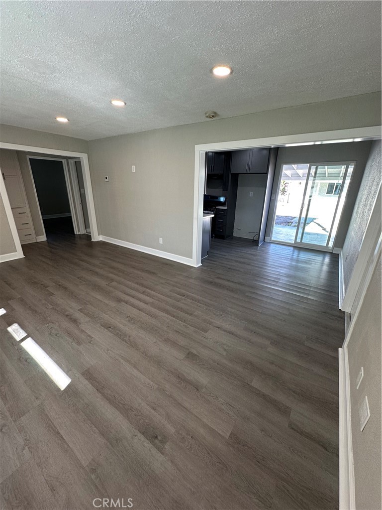 3507 Cortez Street Riverside, CA 92504 - Photo 3 of 10 an empty room with wooden floor and windows