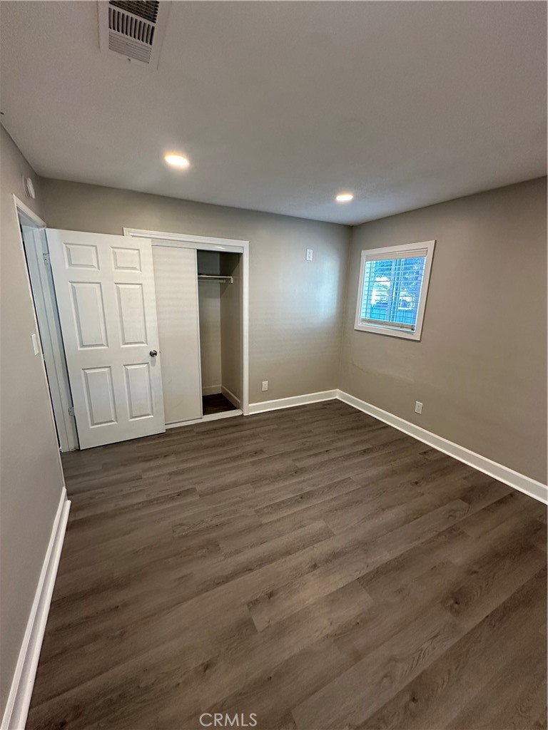 3507 Cortez Street Riverside, CA 92504 - Photo 6 of 10 an empty room with wooden floor and windows