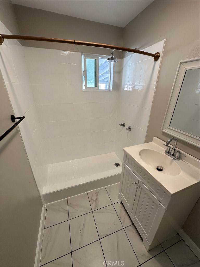 3507 Cortez Street Riverside, CA 92504 - Photo 7 of 10 a bathroom with a sink a shower and a mirror