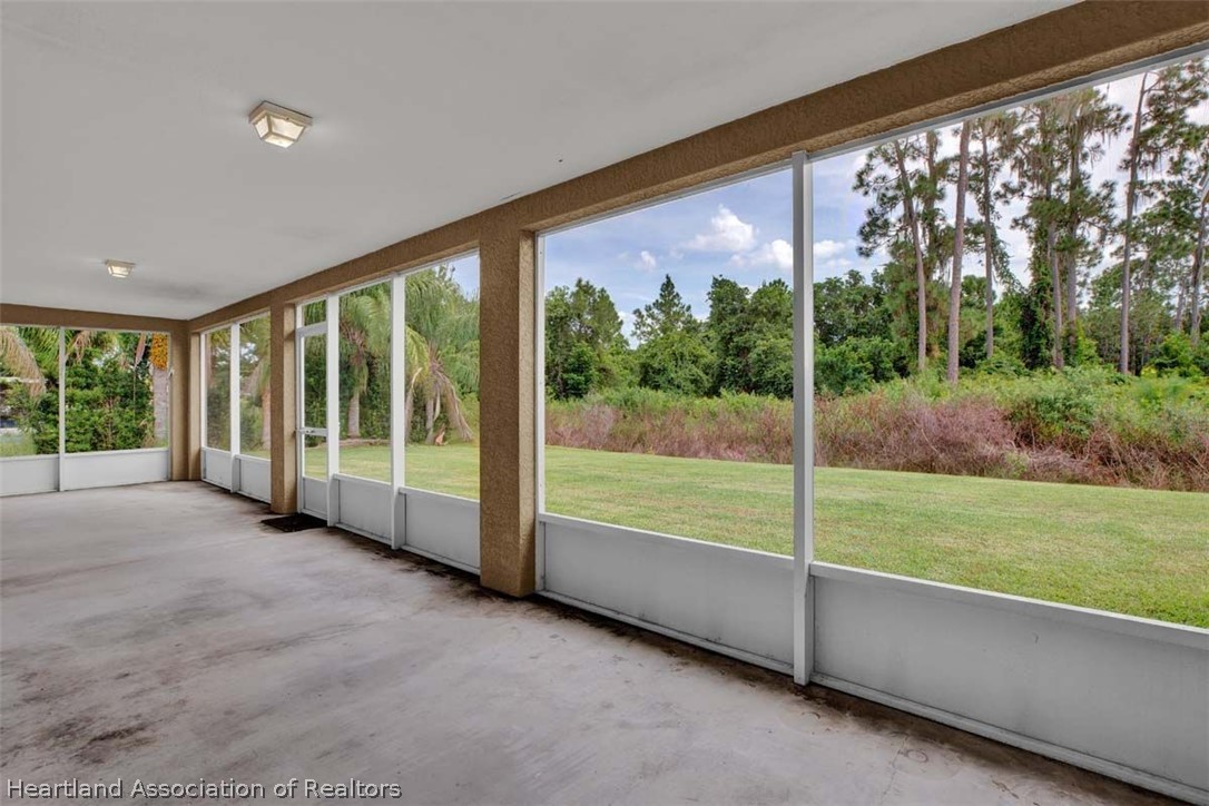 4755 Tarrega Street Sebring, FL 33872 - Photo 13 of 35 a view of an empty room with large windows