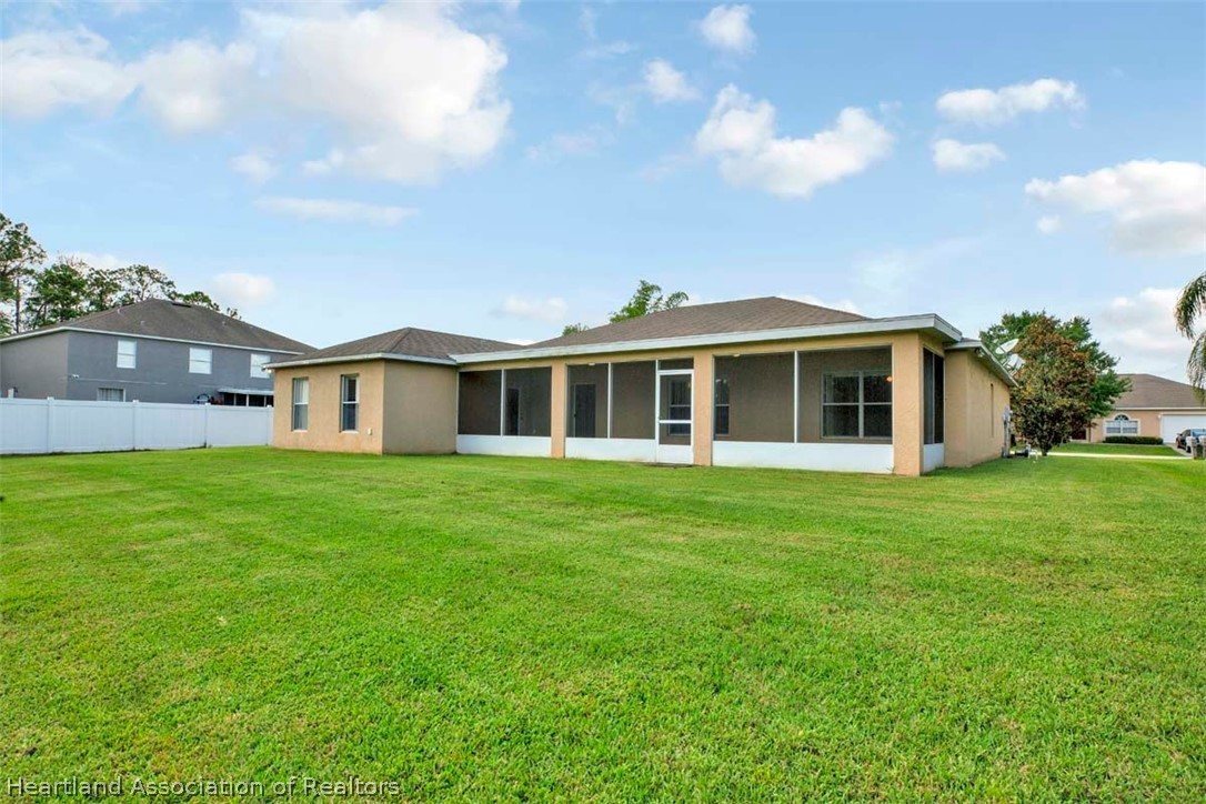 4755 Tarrega Street Sebring, FL 33872 - Photo 19 of 35 a front view of house with yard and green space