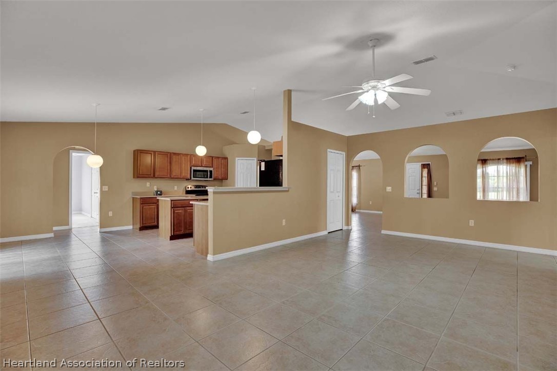 4755 Tarrega Street Sebring, FL 33872 - Photo 2 of 35 a view of a big room with chandelier fan and windows