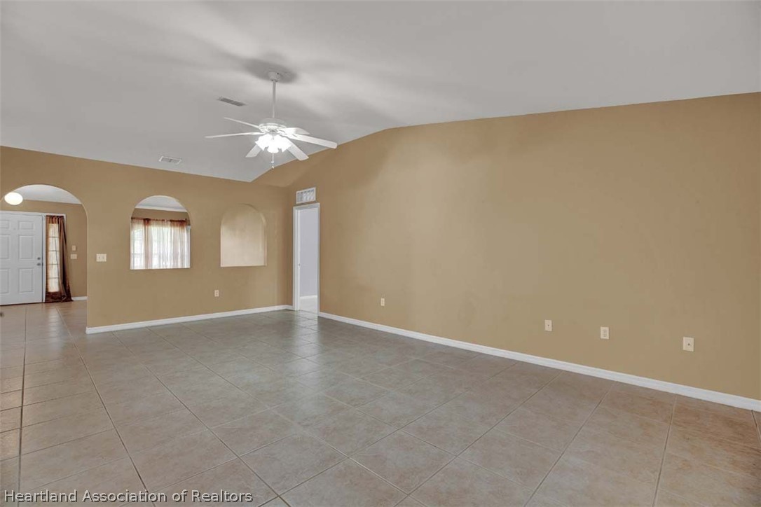 4755 Tarrega Street Sebring, FL 33872 - Photo 22 of 35 an empty room with windows and ceiling fan