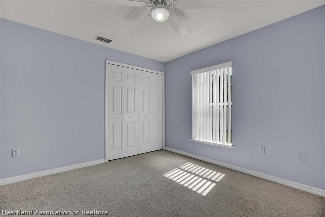 4755 Tarrega Street Sebring, FL 33872 - Photo 23 of 35 an empty room with windows and closet