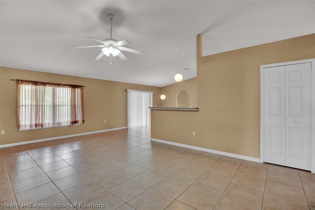 4755 Tarrega Street Sebring, FL 33872 - Photo 25 of 35 a view of an empty room with window and chandelier fan