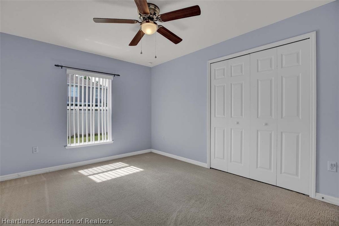 4755 Tarrega Street Sebring, FL 33872 - Photo 29 of 35 an empty room with windows and fan