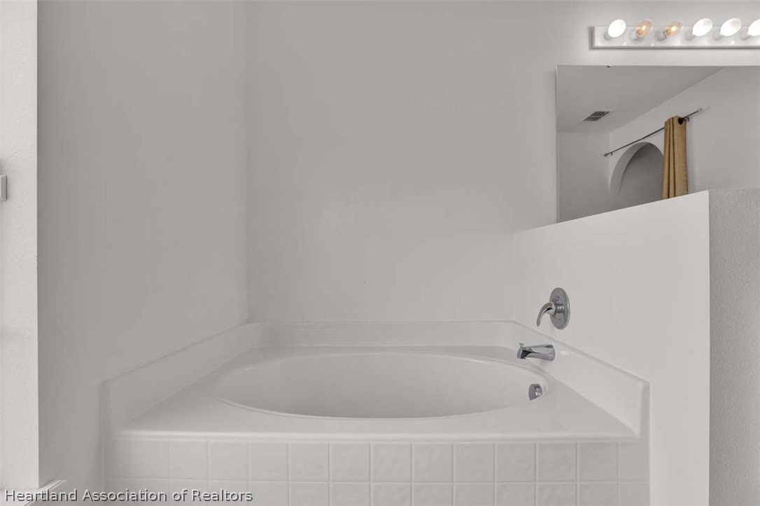 4755 Tarrega Street Sebring, FL 33872 - Photo 30 of 35 a bathroom with a bathtub