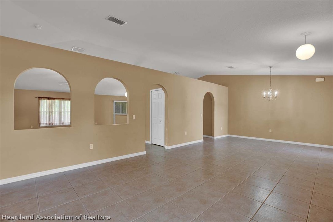 4755 Tarrega Street Sebring, FL 33872 - Photo 31 of 35 a view of an empty room with windows