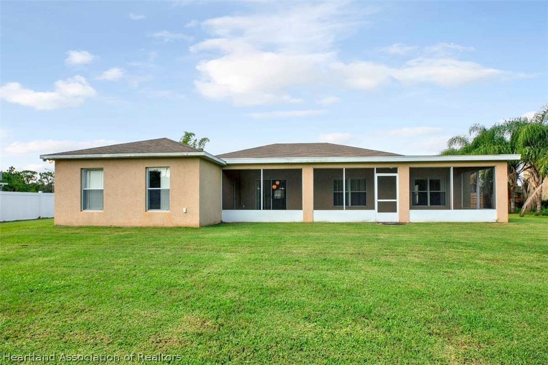 4755 Tarrega Street Sebring, FL 33872 - Photo 33 of 35 front view of a house with a garden