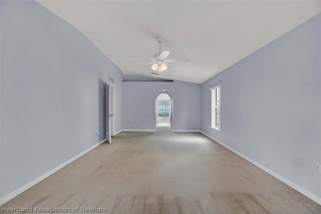4755 Tarrega Street Sebring, FL 33872 - Photo 6 of 35 an empty room with a window and a ceiling fan