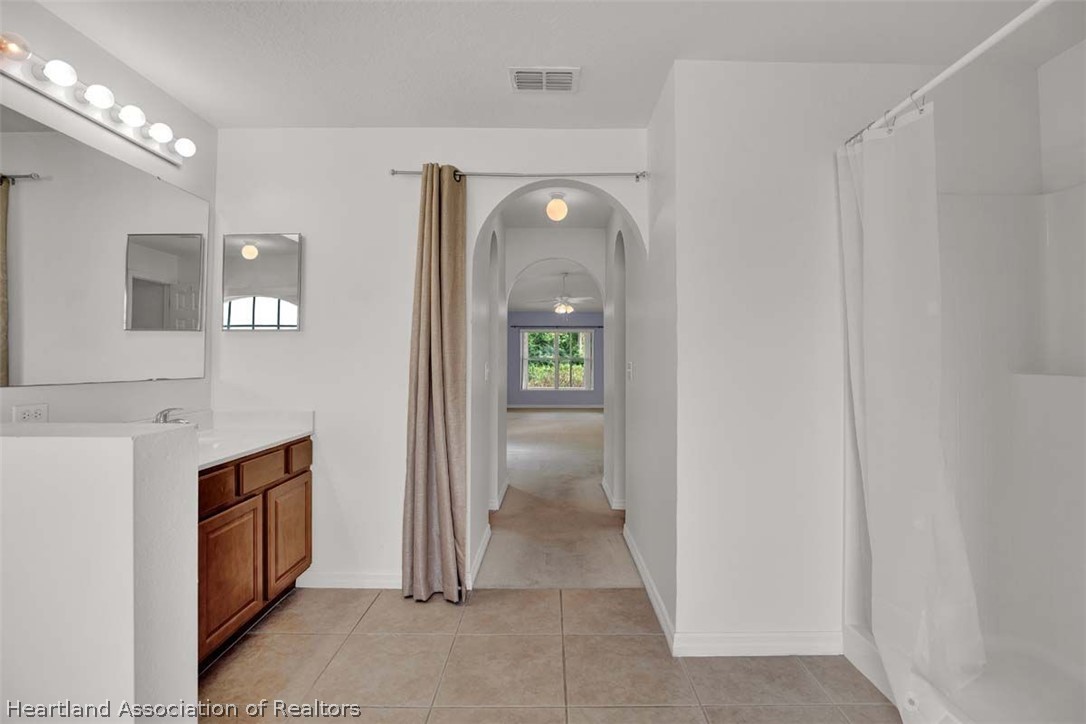 4755 Tarrega Street Sebring, FL 33872 - Photo 10 of 35 a view of a hallway with wooden shelves