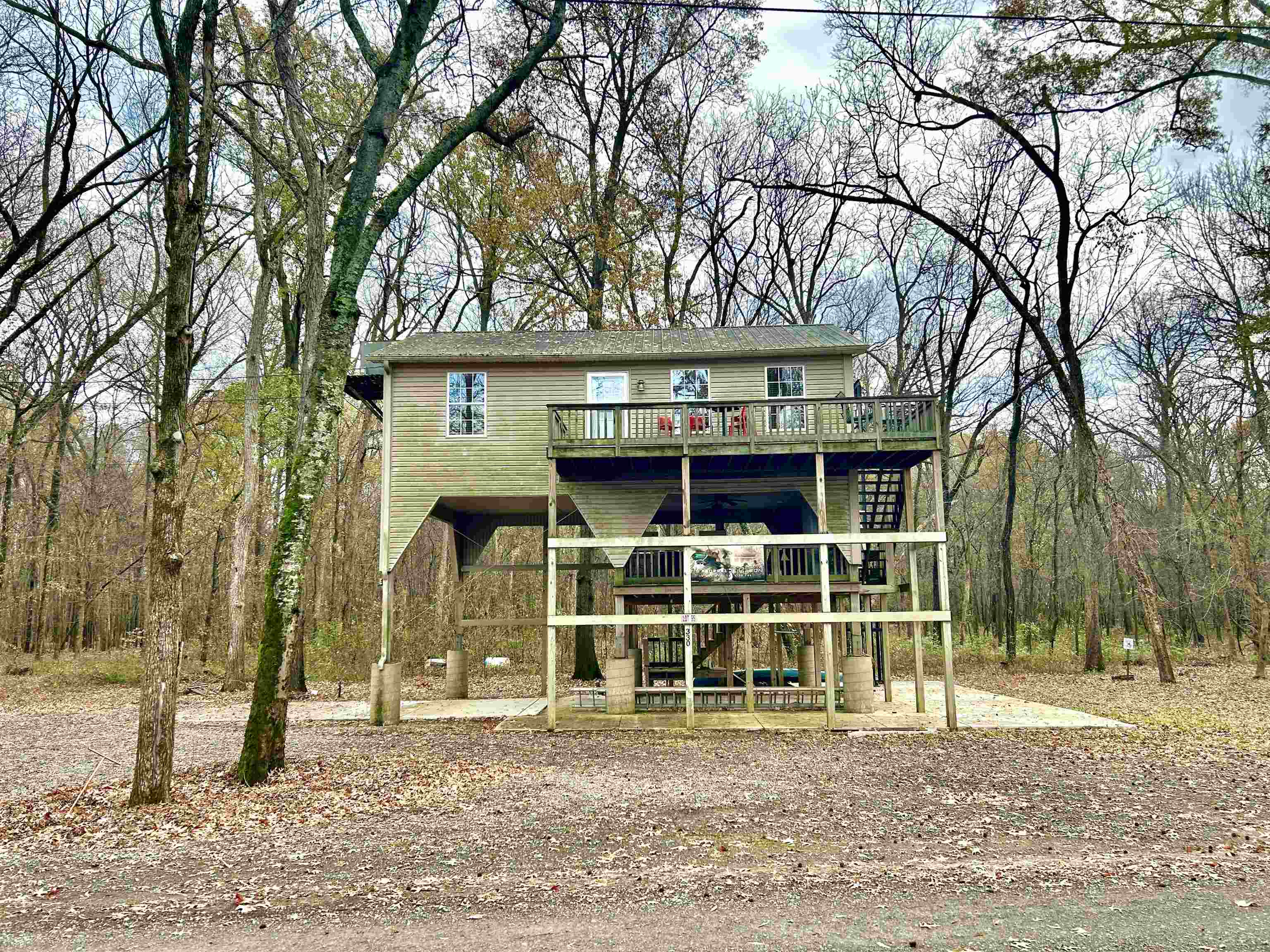 330 Chisholm Lake Camp Road Ripley, TN 38063 - Photo 1 of 13 a front view of a house with a tree