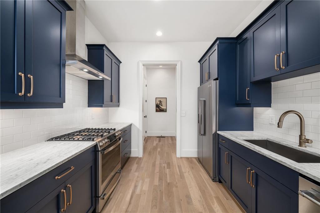 699 Eustace Street Southeast Atlanta, GA 30315 - Photo 13 of 53 a kitchen with stainless steel appliances granite countertop a sink stove and refrigerator