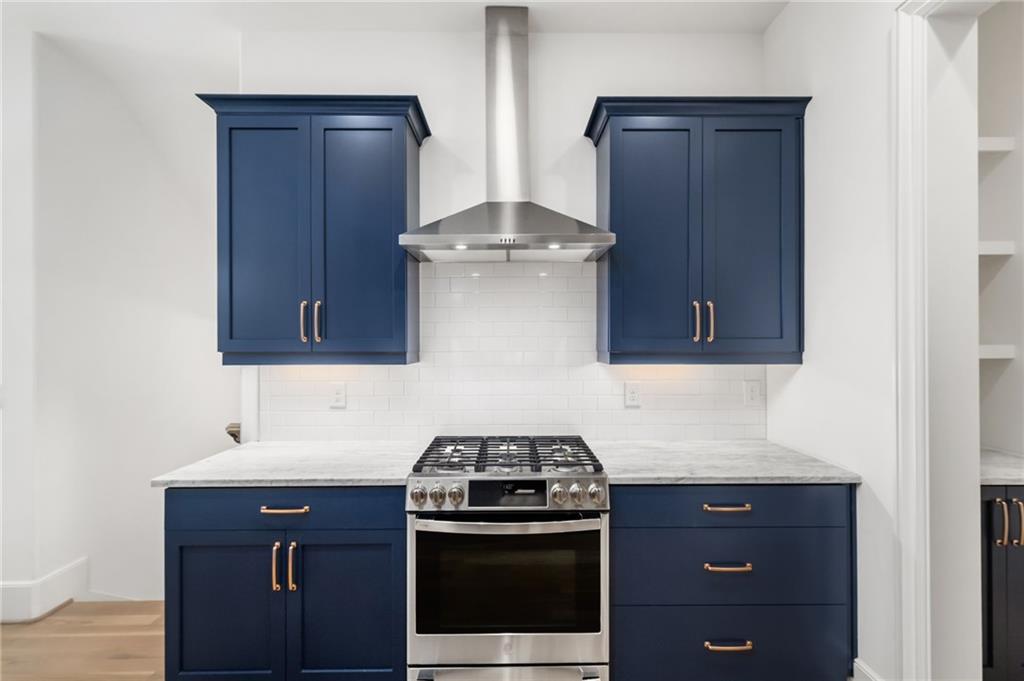 699 Eustace Street Southeast Atlanta, GA 30315 - Photo 14 of 53 a kitchen with stainless steel appliances granite countertop a stove and a microwave oven