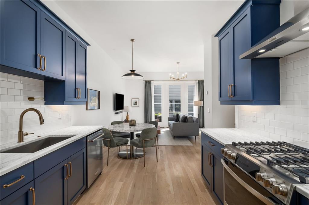 699 Eustace Street Southeast Atlanta, GA 30315 - Photo 15 of 53 a kitchen with sink stove and cabinets