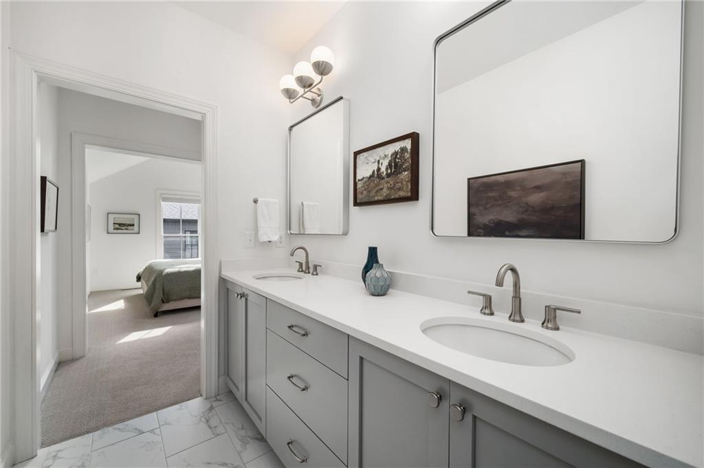 699 Eustace Street Southeast Atlanta, GA 30315 - Photo 26 of 53 a en suite bathroom with double sink and a mirror