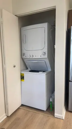 a utility room with wooden floor washer and dryer