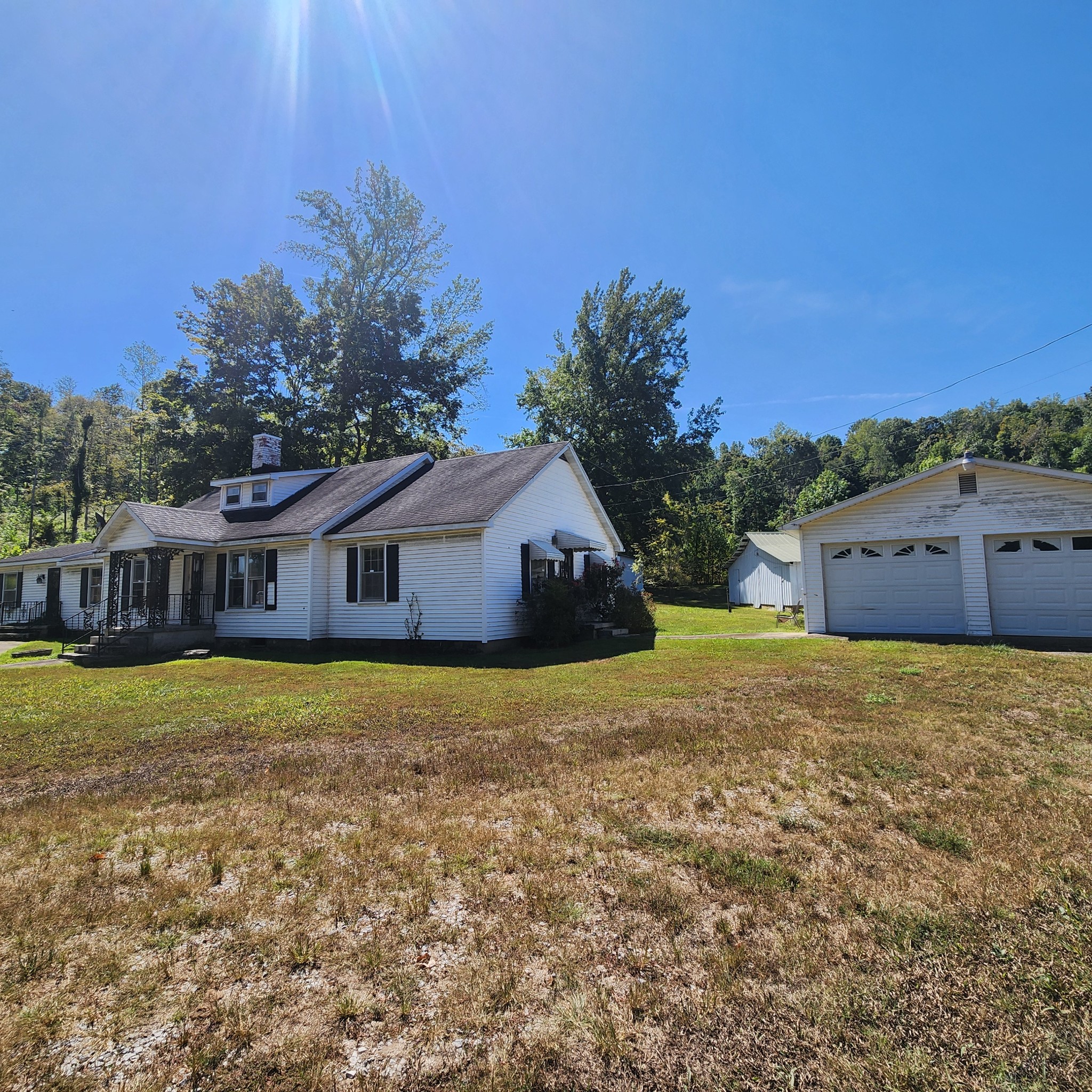 229 Bob Walker Road Bumpus Mills, TN 37028 - Photo 2 of 8 a backyard of a house with large trees and outdoor space
