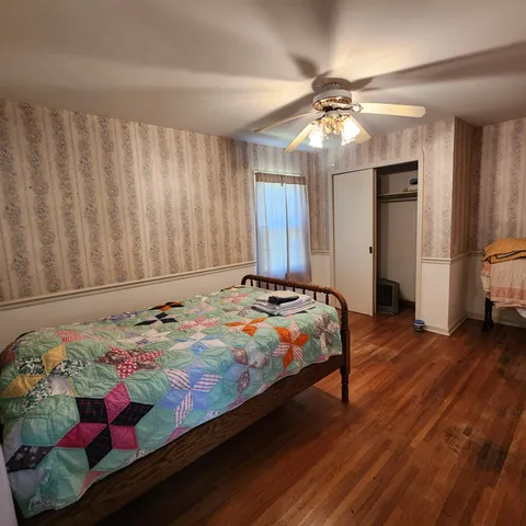 a bedroom with bed and a chandelier