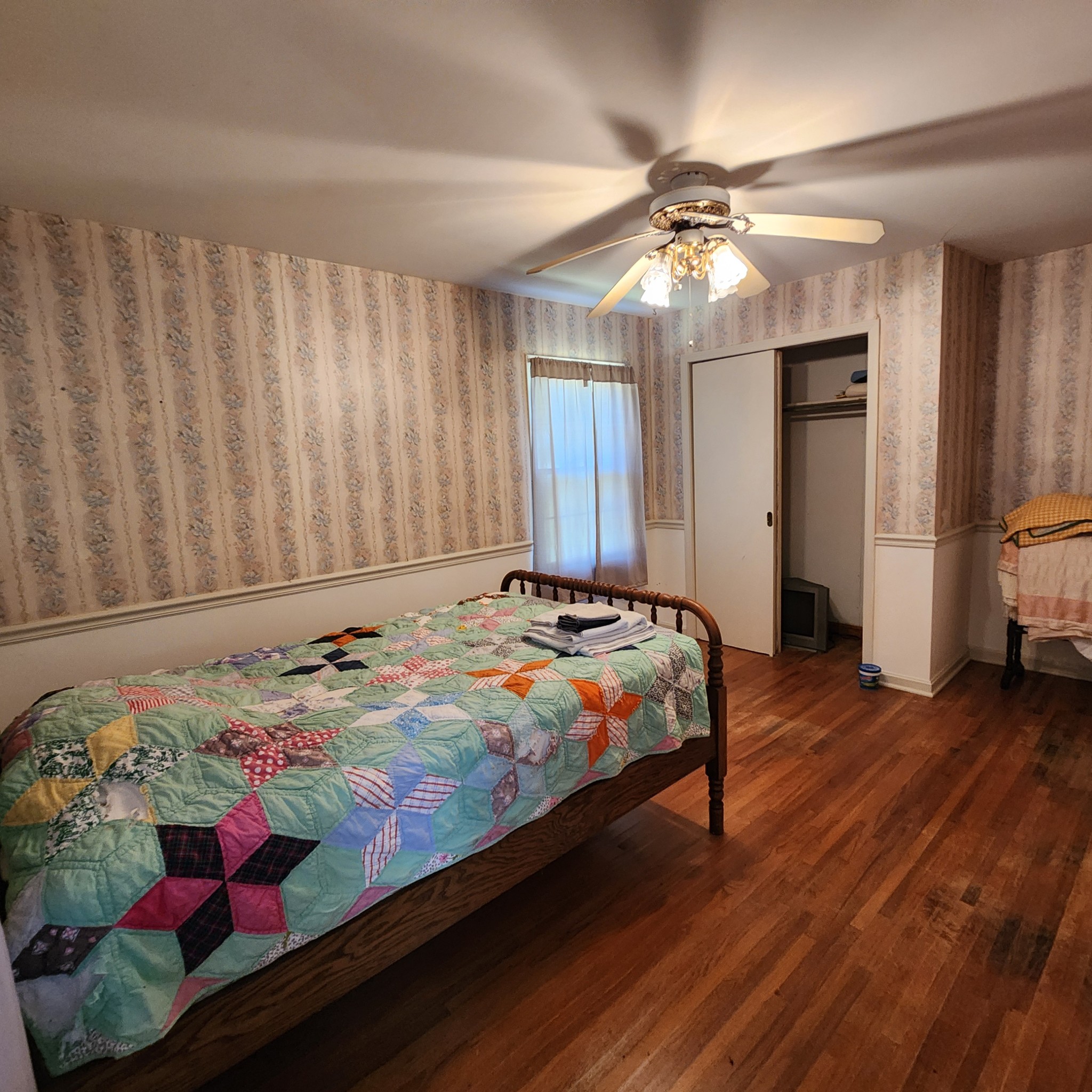 229 Bob Walker Road Bumpus Mills, TN 37028 - Photo 6 of 8 a bedroom with bed and a chandelier