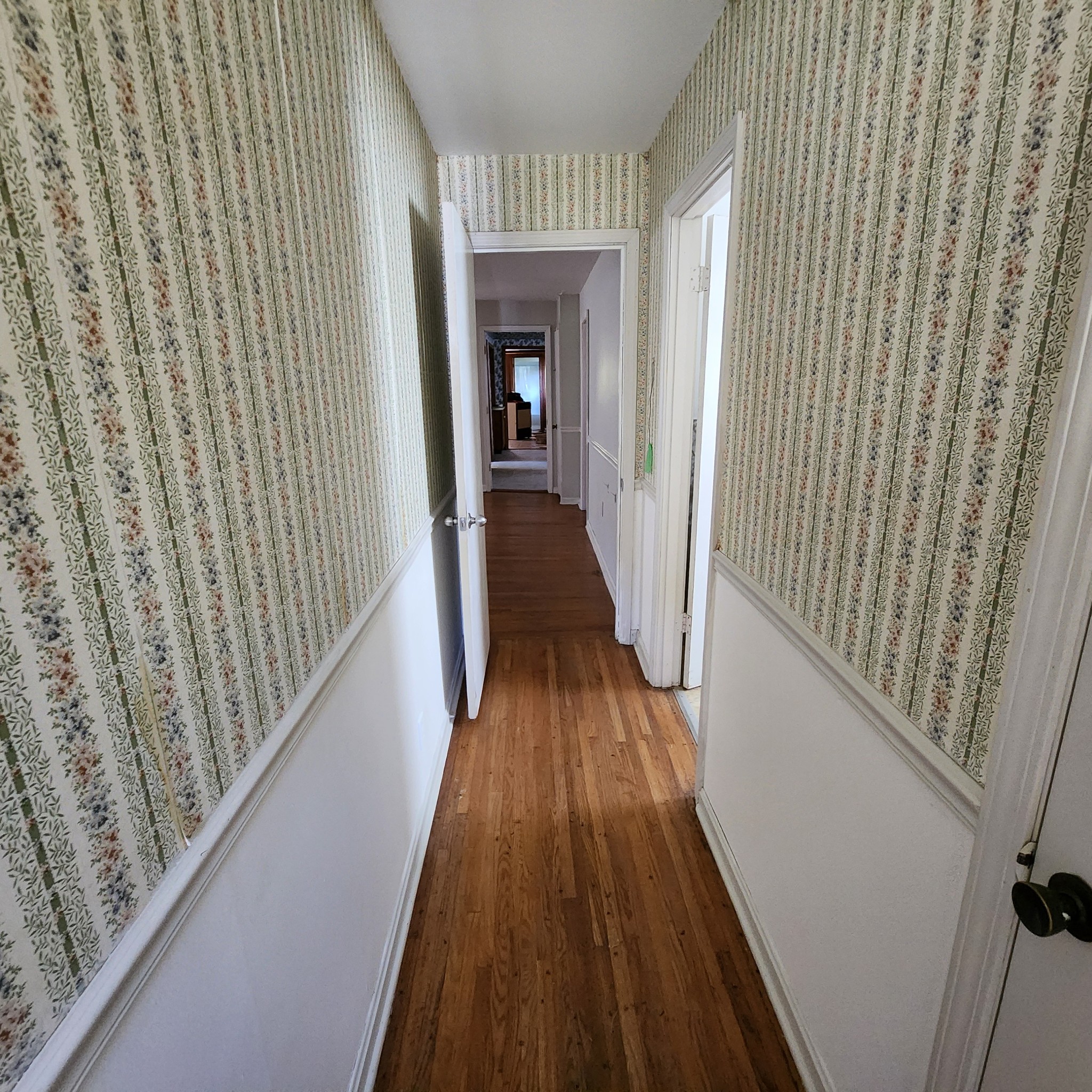229 Bob Walker Road Bumpus Mills, TN 37028 - Photo 7 of 8 a view of a hallway with wooden floor and staircase