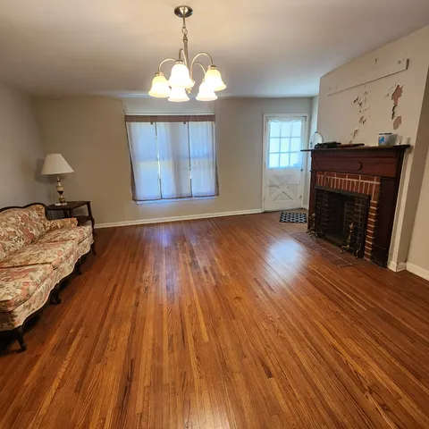 a bedroom with bed and wooden floor