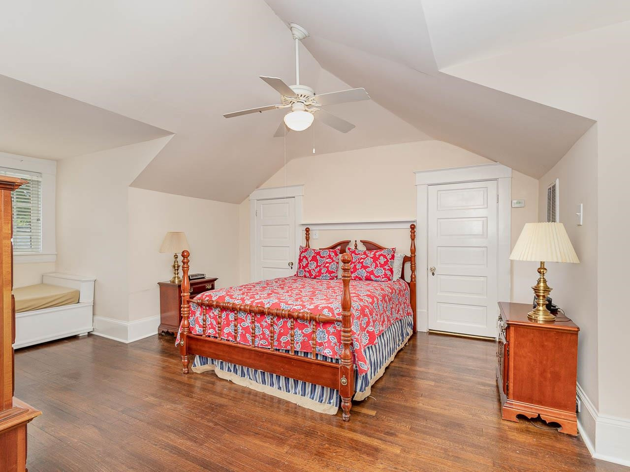401 West Whitaker Mill Road Raleigh, NC 27608 - Photo 16 of 30 a bedroom with a bed and a chandelier