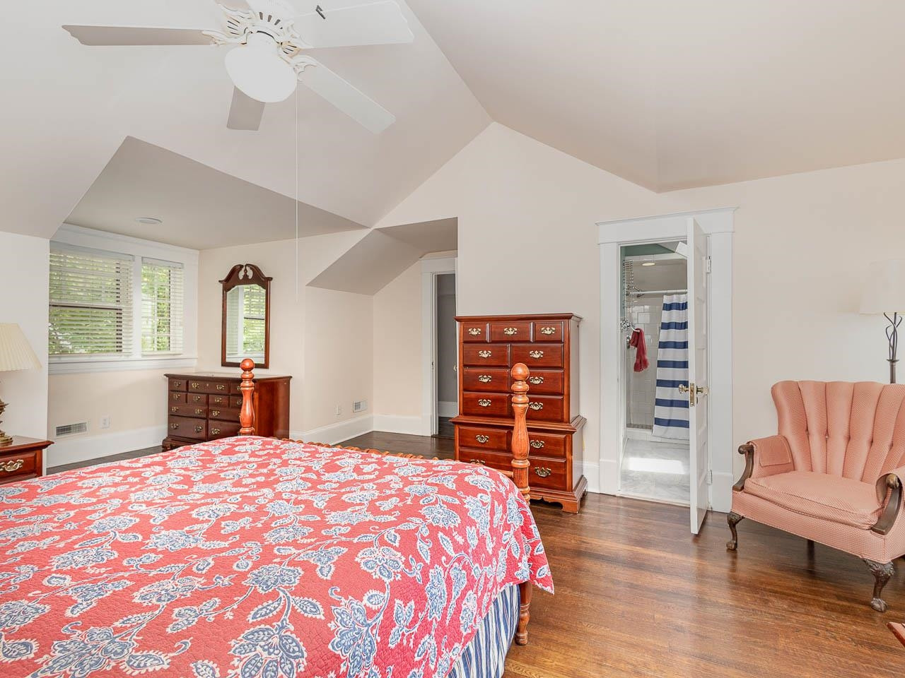 401 West Whitaker Mill Road Raleigh, NC 27608 - Photo 17 of 30 a bedroom with a large bed and a wooden floor