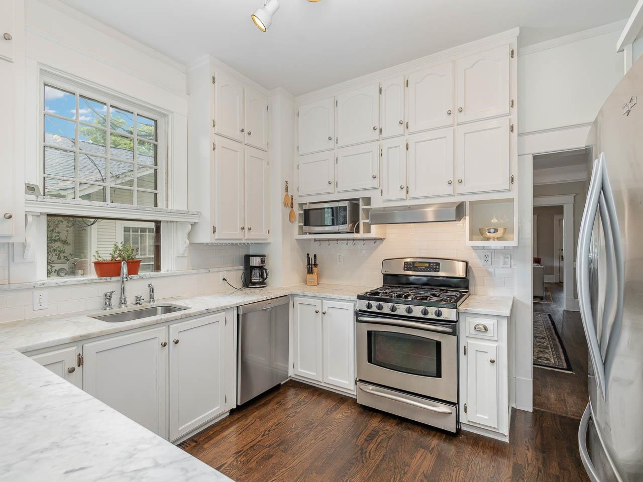 401 West Whitaker Mill Road Raleigh, NC 27608 - Photo 21 of 30 a kitchen with white cabinets and white appliances
