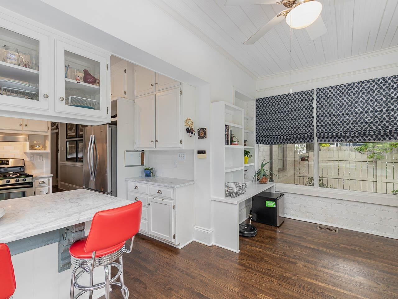 401 West Whitaker Mill Road Raleigh, NC 27608 - Photo 24 of 30 a kitchen with stainless steel appliances kitchen island granite countertop a rug a stove a dining table and chairs with wooden floor