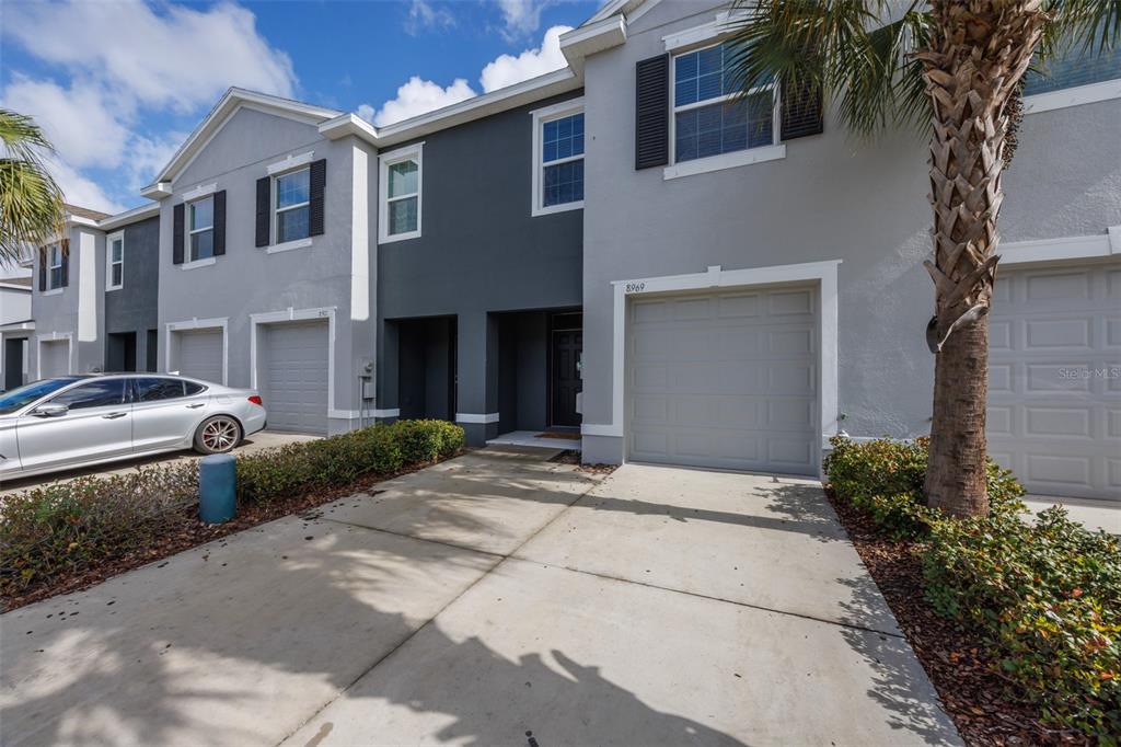 8969 Indigo Trail Loop Riverview, FL 33578 - Photo 2 of 41 a couple of cars parked in front of brick building