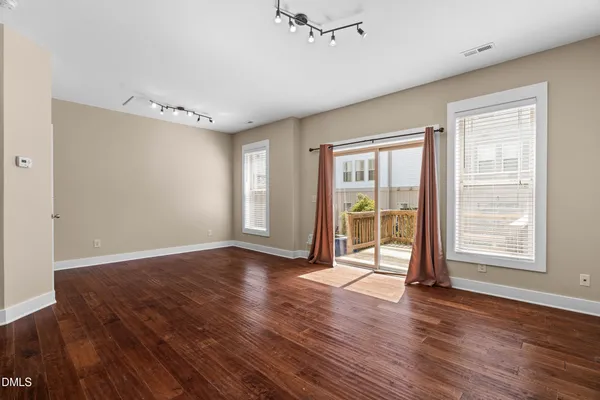 a view of a room with wooden floor and white walls