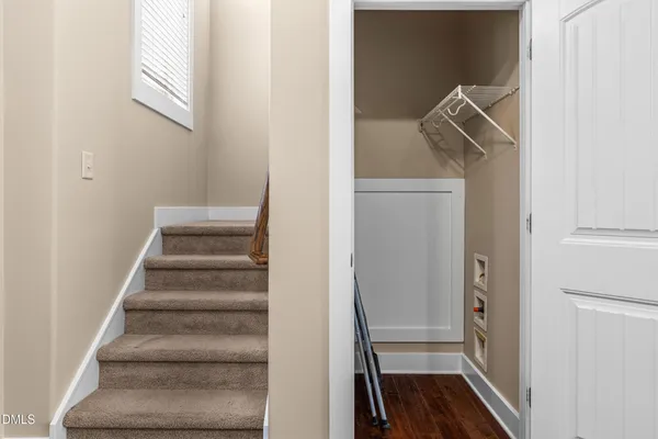 a view of an empty room with closet and entryway
