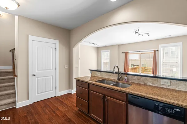 a kitchen with a sink a refrigerator a microwave and cabinets