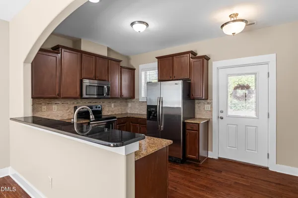 a kitchen with stainless steel appliances granite countertop a sink and cabinets